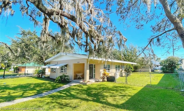 rear view of house featuring a lawn