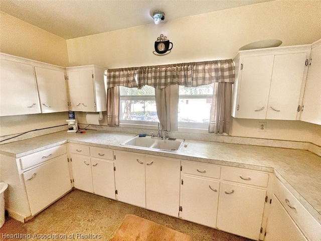 kitchen featuring white cabinetry and sink