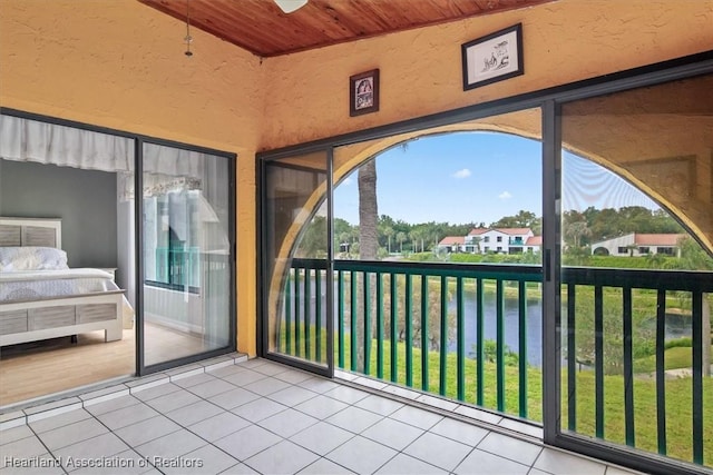 unfurnished sunroom with ceiling fan and wooden ceiling