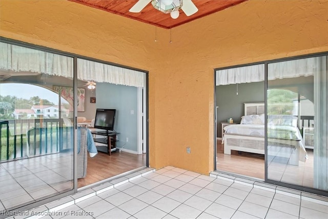 interior space with ceiling fan and wood ceiling