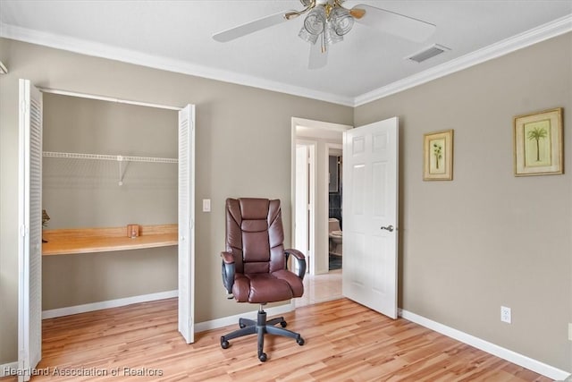 sitting room with built in desk, light hardwood / wood-style flooring, and crown molding