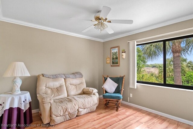 living area with crown molding, ceiling fan, a healthy amount of sunlight, and light wood-type flooring