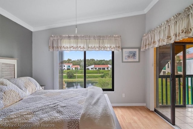 bedroom with access to exterior, a water view, ornamental molding, and wood-type flooring