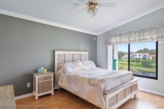 bedroom featuring ceiling fan, lofted ceiling, crown molding, and light hardwood / wood-style flooring