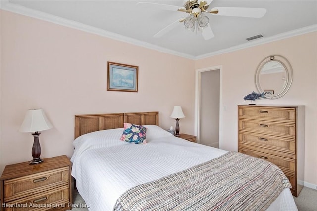 carpeted bedroom with ceiling fan and ornamental molding