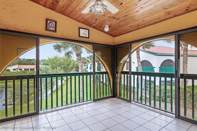 unfurnished sunroom with ceiling fan, wooden ceiling, and vaulted ceiling