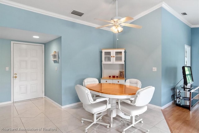 dining space featuring ceiling fan and crown molding