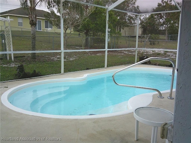 outdoor pool with glass enclosure and fence