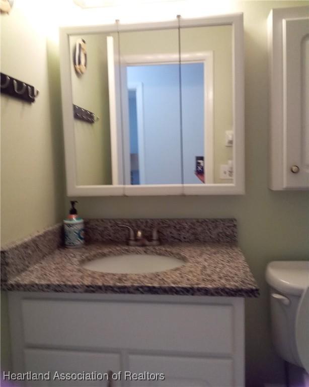 bathroom featuring toilet and vanity