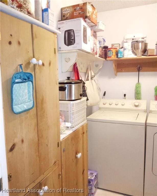 clothes washing area featuring washer and clothes dryer and laundry area