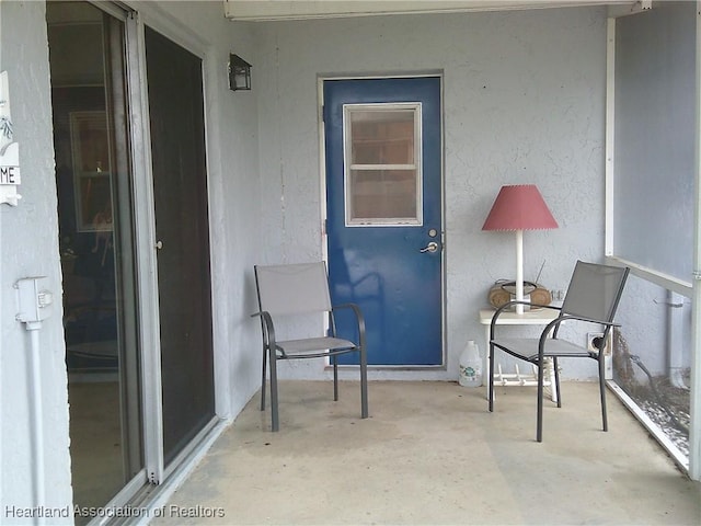 view of exterior entry featuring stucco siding