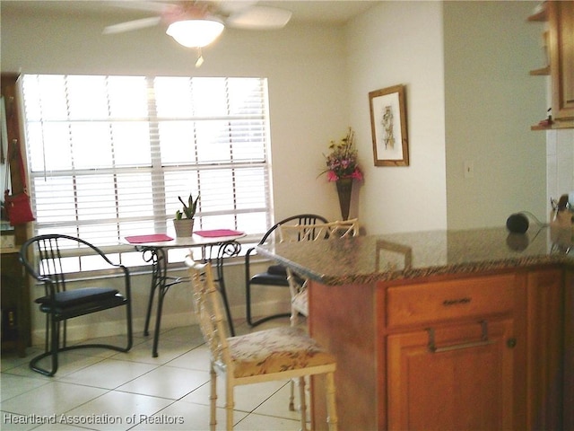 dining area featuring light tile patterned flooring and ceiling fan