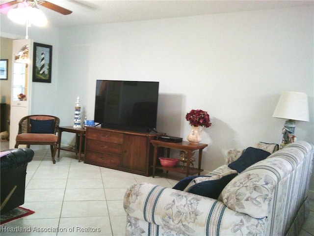 living area featuring light tile patterned floors and a ceiling fan