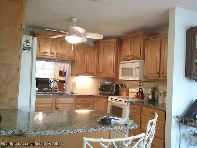 kitchen featuring white appliances, a textured ceiling, a toaster, a sink, and ceiling fan