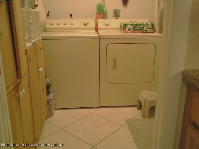 washroom with laundry area, light tile patterned floors, and separate washer and dryer