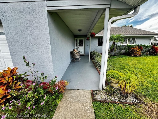 doorway to property featuring a lawn