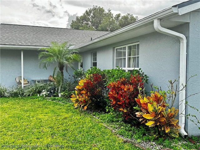 view of property exterior with a yard