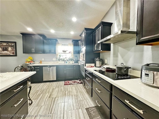 kitchen featuring sink, wall chimney range hood, stainless steel dishwasher, a textured ceiling, and black electric stovetop