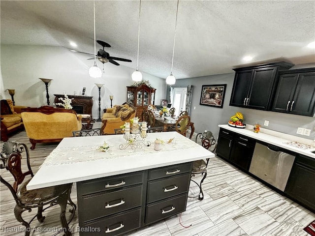 kitchen with ceiling fan, a kitchen breakfast bar, stainless steel dishwasher, decorative light fixtures, and a kitchen island