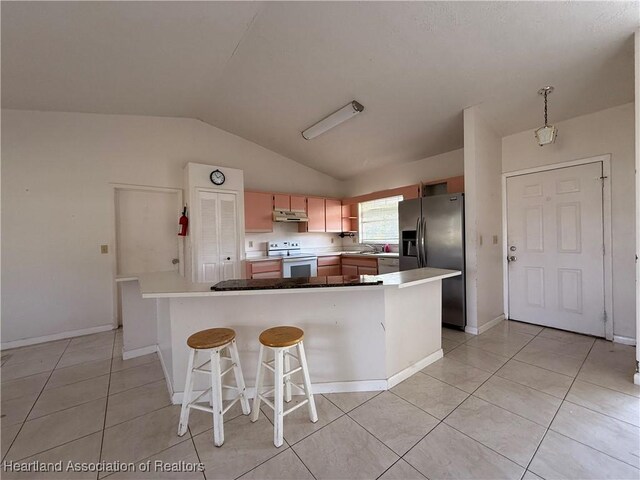 kitchen with white electric range oven, stainless steel fridge, vaulted ceiling, under cabinet range hood, and light tile patterned floors