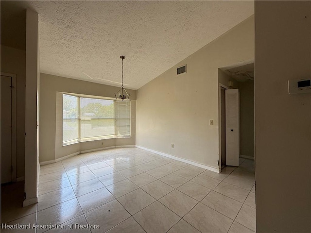 unfurnished dining area with lofted ceiling, an inviting chandelier, visible vents, light tile patterned floors, and a textured ceiling