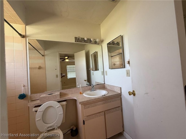 bathroom with ceiling fan, toilet, and vanity