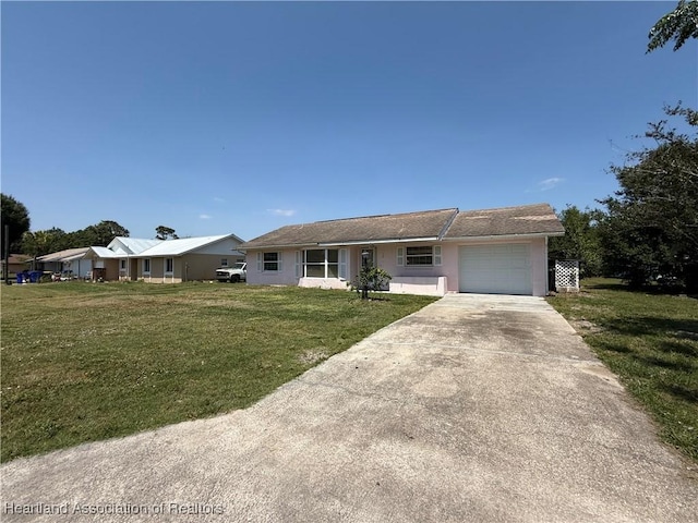 ranch-style home featuring stucco siding, driveway, a front yard, and a garage