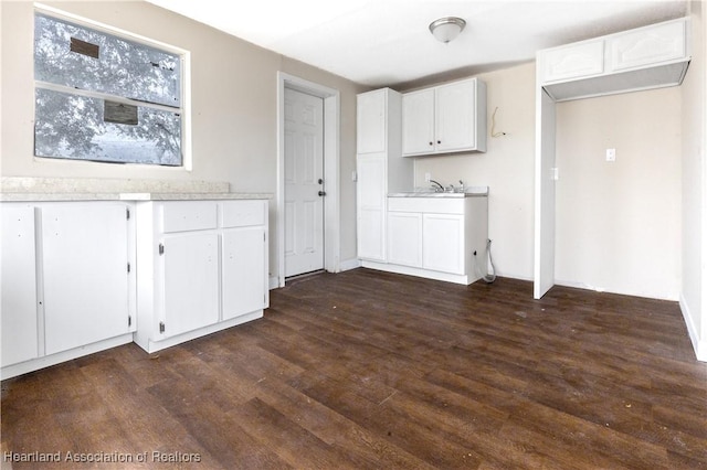 kitchen featuring white cabinets and dark hardwood / wood-style flooring