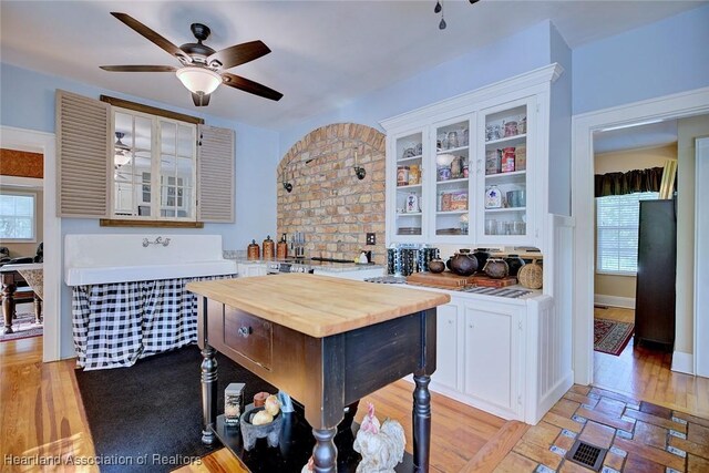 1237 Hotiyee Ave, Sebring, FL 33870 - kitchen with butcher block counters, a ceiling fan, white cabinetry, and plenty of natural light