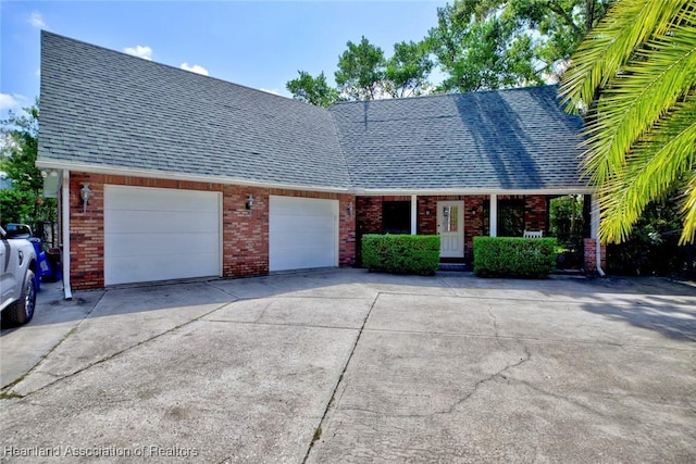1237 Hotiyee Ave, Sebring, FL 33870 - view of front of home featuring driveway, brick siding, a garage, and roof with shingles