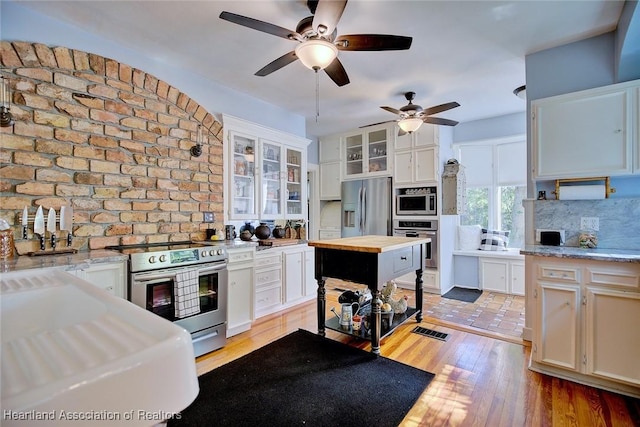 1237 Hotiyee Ave, Sebring, FL 33870 - kitchen featuring stainless steel appliances, wood counters, ceiling fan, light wood finished floors, and tasteful backsplash