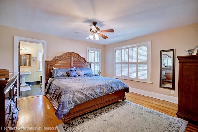 1237 Hotiyee Ave, Sebring, FL 33870 - bedroom with wood finished floors, ensuite bathroom, and a ceiling fan