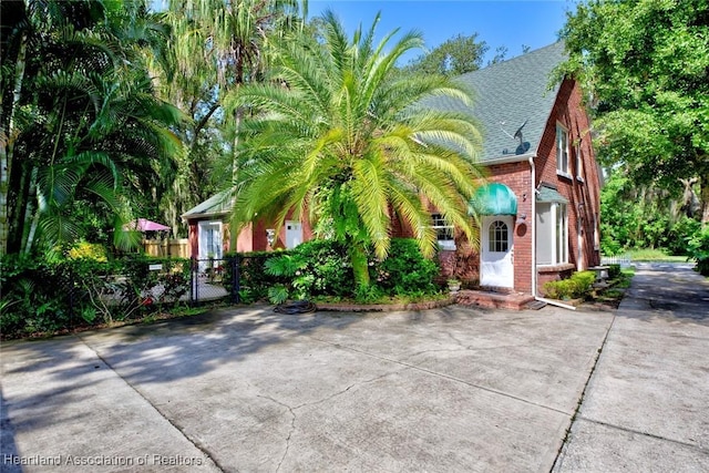 1237 Hotiyee Ave, Sebring, FL 33870 - view of front of house with brick siding and a shingled roof