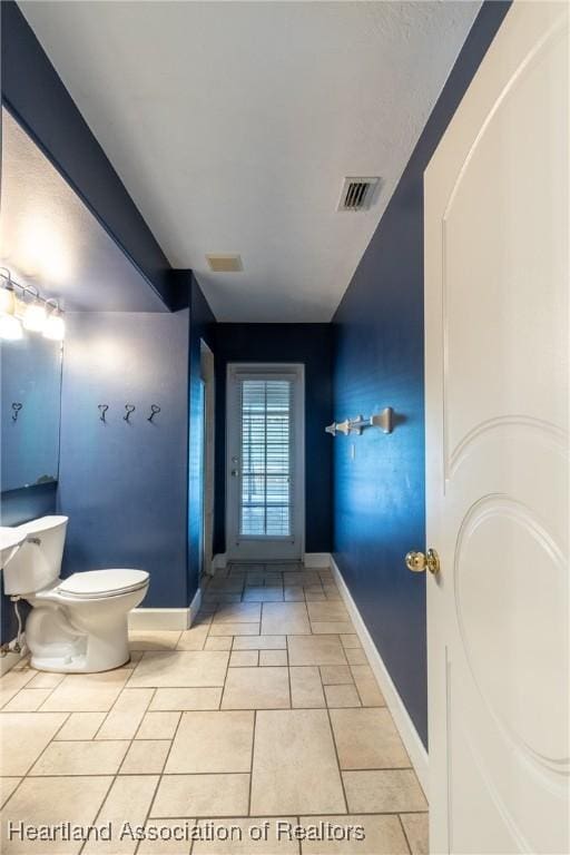 bathroom with tile patterned flooring and toilet