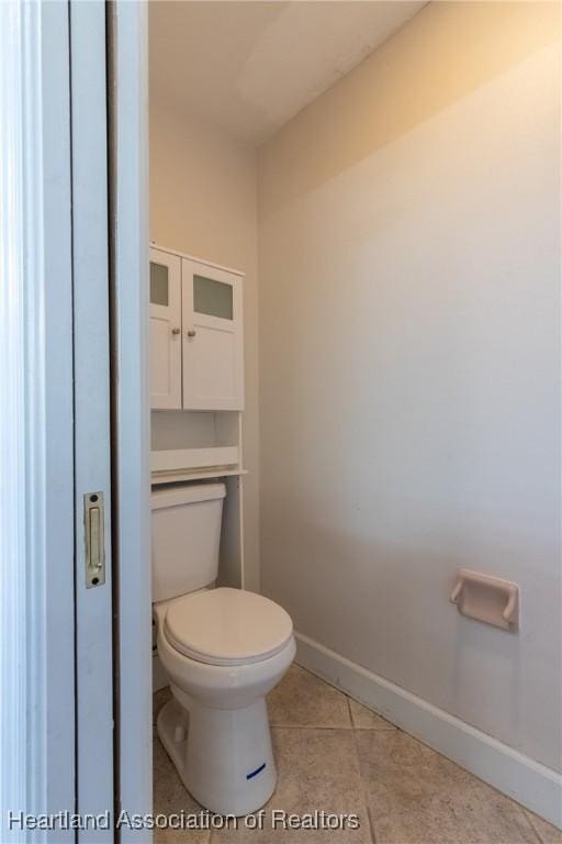 bathroom with tile patterned flooring and toilet