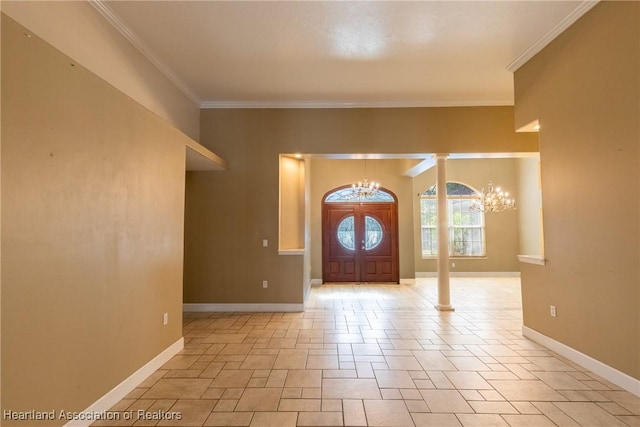 entryway featuring decorative columns, an inviting chandelier, and ornamental molding