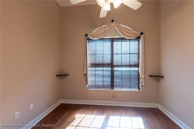 empty room featuring ceiling fan and dark hardwood / wood-style flooring