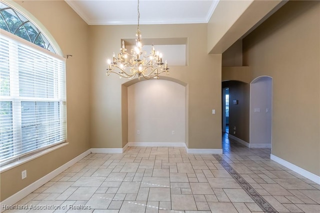 empty room with an inviting chandelier and crown molding