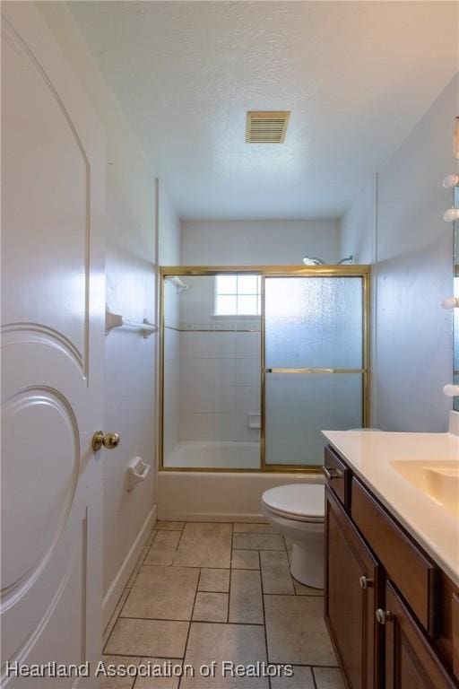 full bathroom with vanity, toilet, and bath / shower combo with glass door