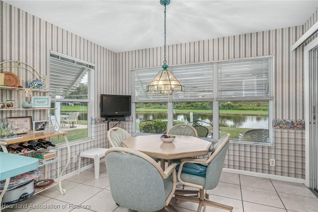 tiled dining room featuring a chandelier