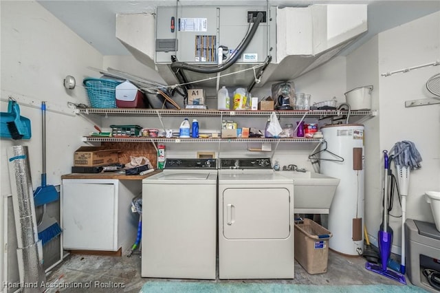 washroom with washer and clothes dryer and water heater