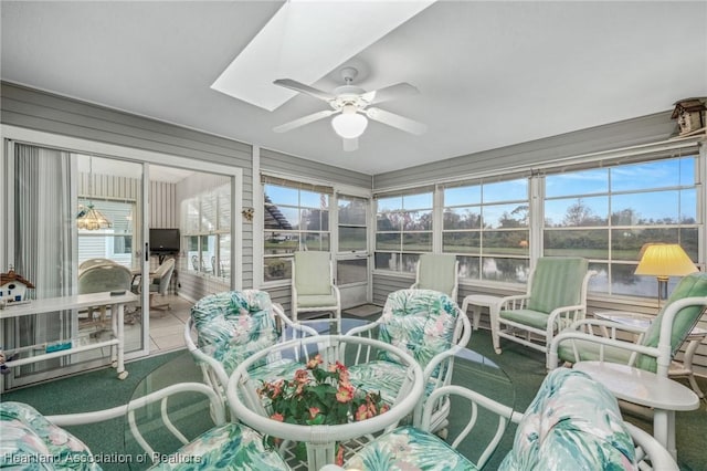 sunroom / solarium featuring ceiling fan