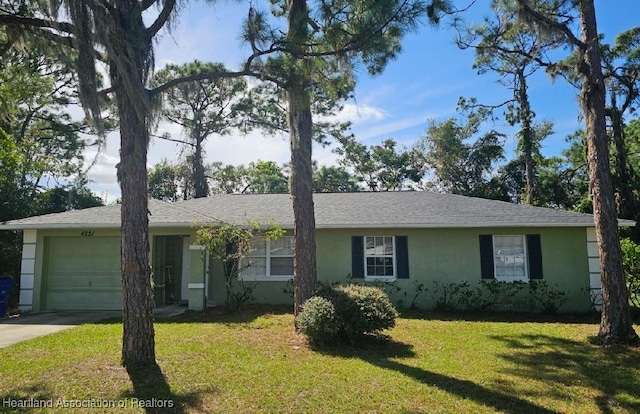 ranch-style home featuring a front yard, driveway, an attached garage, and stucco siding