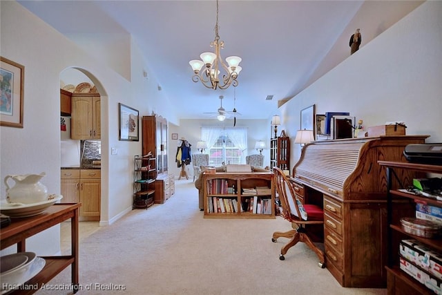 carpeted office featuring ceiling fan with notable chandelier and vaulted ceiling