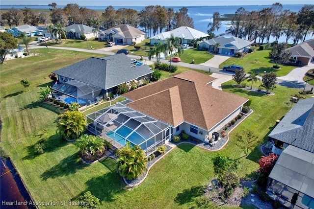 birds eye view of property with a water view