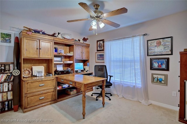 home office featuring ceiling fan, a healthy amount of sunlight, and light colored carpet