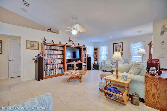 living room featuring ceiling fan, light tile patterned floors, and lofted ceiling