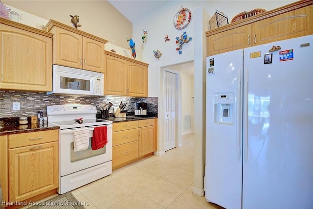 kitchen with light brown cabinets, white appliances, tasteful backsplash, and light tile patterned floors