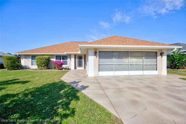 ranch-style home with a garage and a front lawn