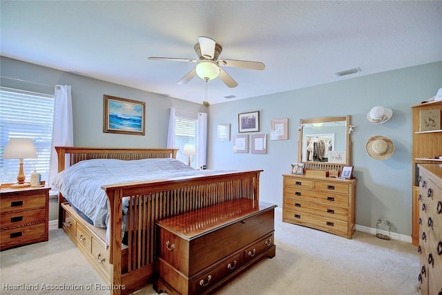 bedroom featuring ceiling fan and light carpet